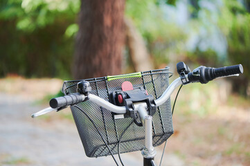 Detail of the basket, bell and handle bar of an utility bike. Bicycle parts close up.