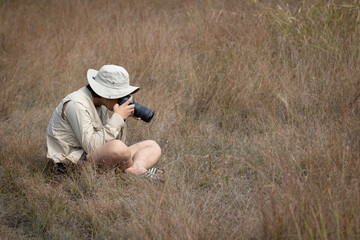 Photographer is taking a picture of scenic landscape.