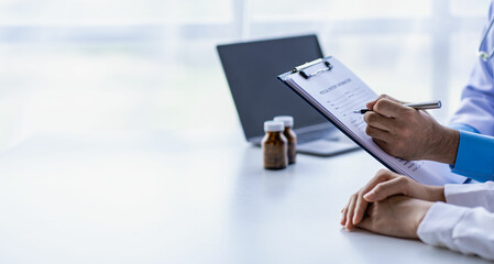 Psychiatrist consulting on women's gynecological diseases, writing prescription clipboard notes, listening to patients received in the clinic hospital.