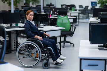 Caucasian woman wheelchair in open space office.