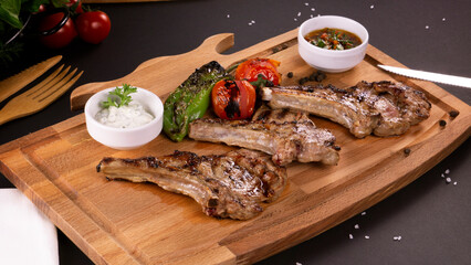 Pirzola Meat Kebabs Tomatoes and Onions and Grits on a board
