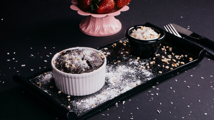 Chocolate cake in a mug with powdered sugar
