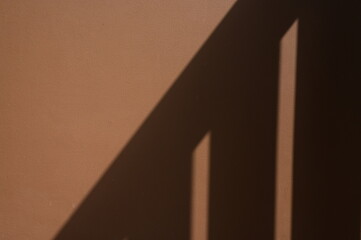brown wall textured background with railing shadow