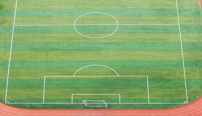 Top view of empty soccer field with goal posts