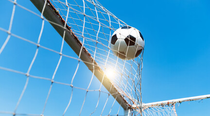 Football goal net against blue sky