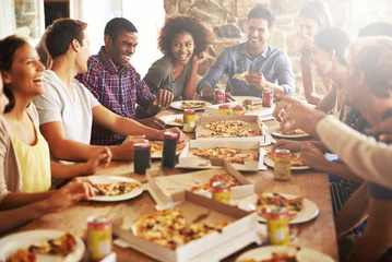 Foto op Aluminium Friends, happy with pizza at restaurant, fast food and soda with group on lunch or dinner date, happiness and nutrition. Food, friendship and meal at New York pizzeria, party and social gathering. © Arcurs Co-op/peopleimages.com