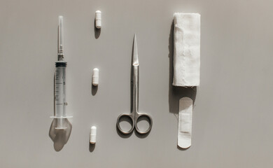 Tools to help the patient. For dressing the wound - scissors, bandages, adhesive plaster. For anesthesia syringes and tablets. View from above.