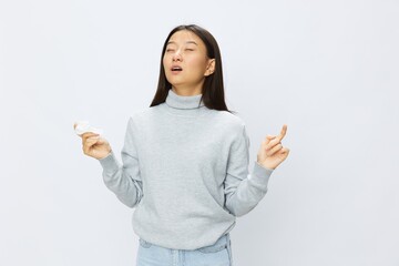 Asian woman holding hand with handkerchief and coughing up flu and cold, stuffy nose viral disease asthma and allergies covid 19 white background