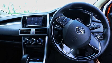 close-up of car start and stop buttons. Modern car interior with cockpit dashboard and steering...