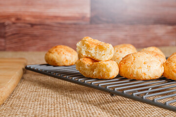 Cheese bread on cooling rack close-up. Traditional Brazilian cheese bread balls close-up with copy space