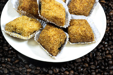 plate of Fried Makrout or makroud - Algerian semolina, dates and honey sweets, traditional North Africa sweet food for islam on grain coffee