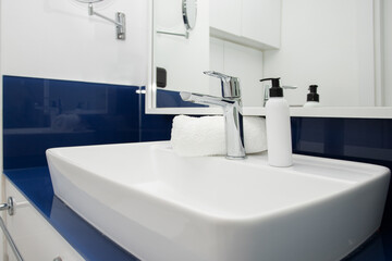 bathroom sink with dispenser and towel