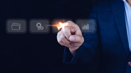 Businessman pointing finger touching to select flight by pressing touch screen airplane button,Business Airplane transportation concept