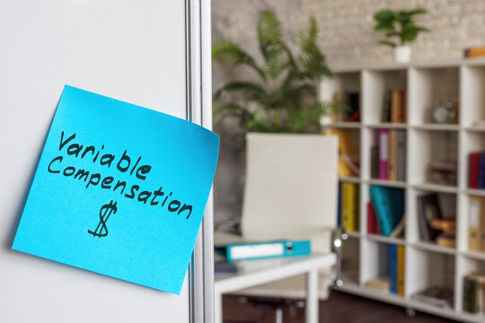 Variable compensation written on a sticker. Whiteboard in the office.