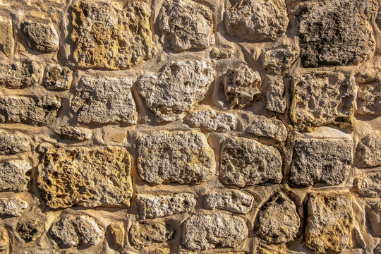 Old sandstone brick wall close-up. High resolution photo.