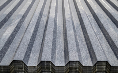 Metal profile for roof covering. Metal profiled sheeting is stored in a bundle in a warehouse for...