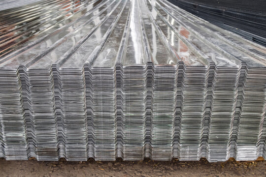 Metal profile for roof covering. Metal profiled sheeting is stored in a bundle in a warehouse for sale.