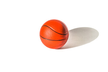 Basketball ball on the floor in the gym lit from the window