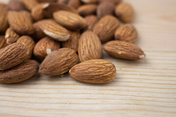 Roasted almonds on wooden background