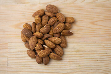 Roasted almonds on wooden background