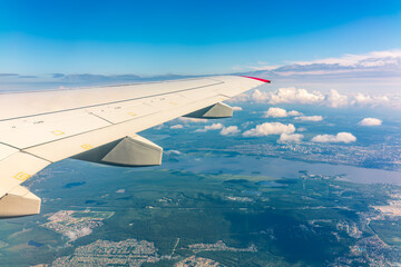Obraz premium View from the airplane window during taking off on a clear summer morning. Yekaterinburg, Russia