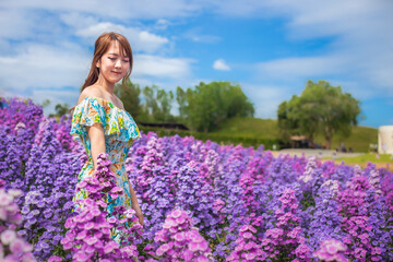 woman wearing a long dress in a field of margaret flowers exudes a relaxed and freedom. Soft and...