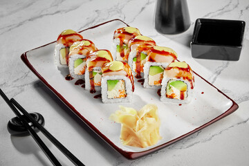 Sushi rolls with cream cheese, avocado, tobiko, butterfish, mayonnaise and unagi sauce