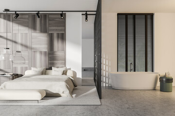 Stylish bedroom interior with sleeping area and tub with accessories
