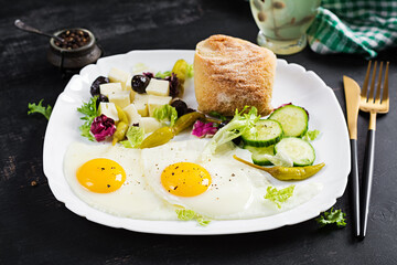 Fried eggs, cheese, hot pepper, olives and cucumber. Paleo breakfast. Turkish breakfast.