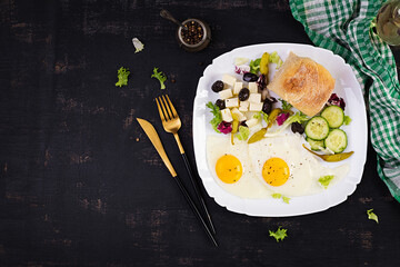Fried eggs, cheese, hot pepper, olives and cucumber. Paleo breakfast. Turkish breakfast. Top view