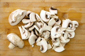 sliced ​​champignons on a wooden board
