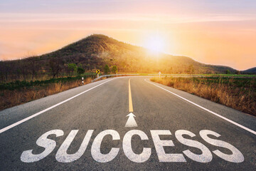  Success written on asphalt road in sunset concept of goals and challenges or career path success business opportunity and change.