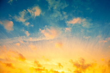 Fototapeta premium Colorful cloudy sky at sunset. Blue yellow gradient color.