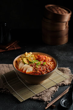 Mee Siam Singapore is a dish of thin rice vermicelli with sour soup on dark background