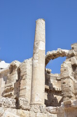 Ancient ruins of Greek and Roman buildings in the Citadel of Amman on a bright sunny day.