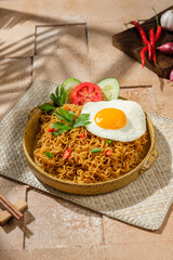 portrait of the most popular noodles in Indonesia with toppings of eggs sunny side up with various garnish
