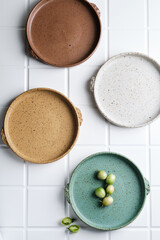 Beautiful artistic plate on white tiles background