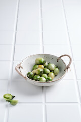 Beautiful artistic bowl on white tiles background