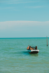 Fototapeta na wymiar a fishing boat bobbing in the sea