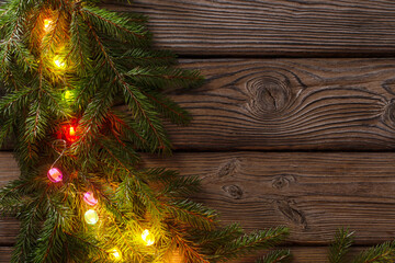 colorful christmas lights on dark wooden background