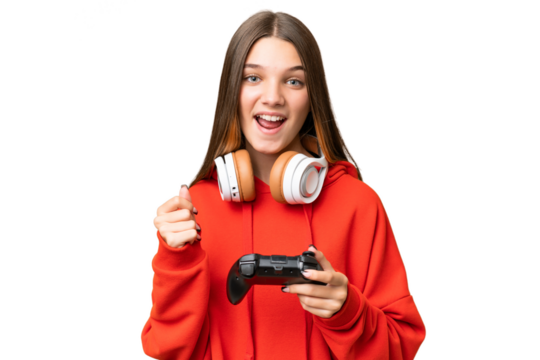 Teenager caucasian girl playing with a video game controller over isolated background celebrating a victory in winner position