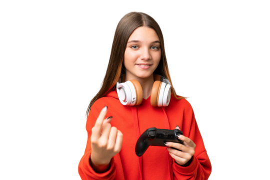 Teenager caucasian girl playing with a video game controller over isolated background doing coming gesture
