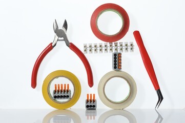 Different tools for electronics repair laid out on a white background