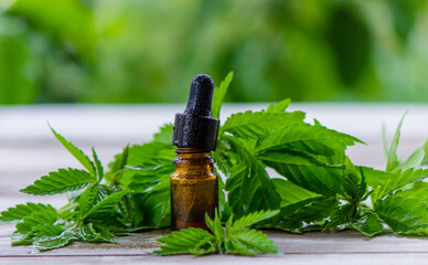 hemp oil in jars close-up. On a wooden background.