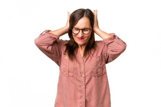Middle-aged caucasian woman over isolated background frustrated and covering ears