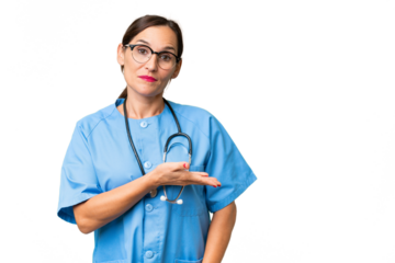 Middle-aged nurse woman over isolated background presenting an idea while looking smiling towards