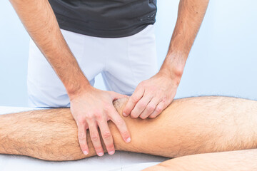 Knee patella mobilization by a physical therapist - obrazy, fototapety, plakaty