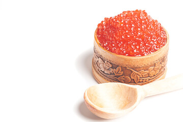 delicious red caviar in wooden bowl isolated on white background.