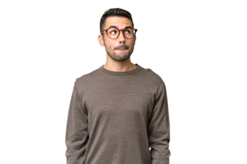 Young handsome caucasian man over isolated background having doubts while looking up