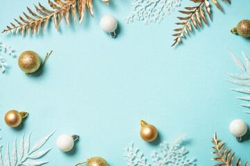 Christmas composition with holiday decorations on blue background. Top view with copy space.